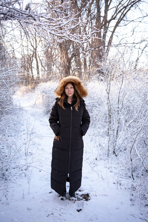 Woman in Jacket Standing in Forest in Winter