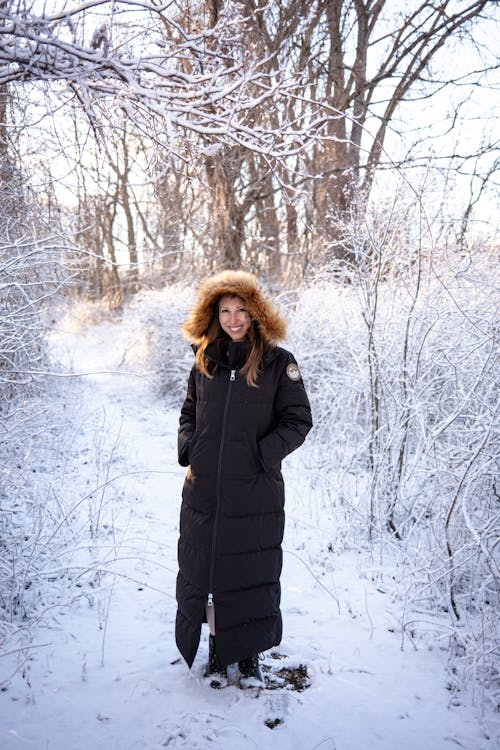 Smiling Woman Posing in Coat in Winter Scenery