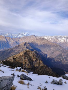 Breathtaking panoramic view of snow-capped mountains and valleys in Tungnath, Uttarakhand.