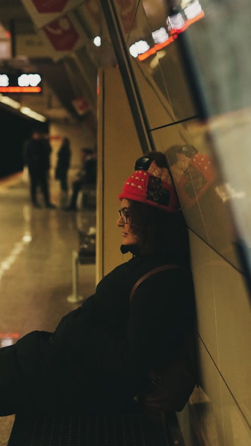Woman Sitting at Metro Station