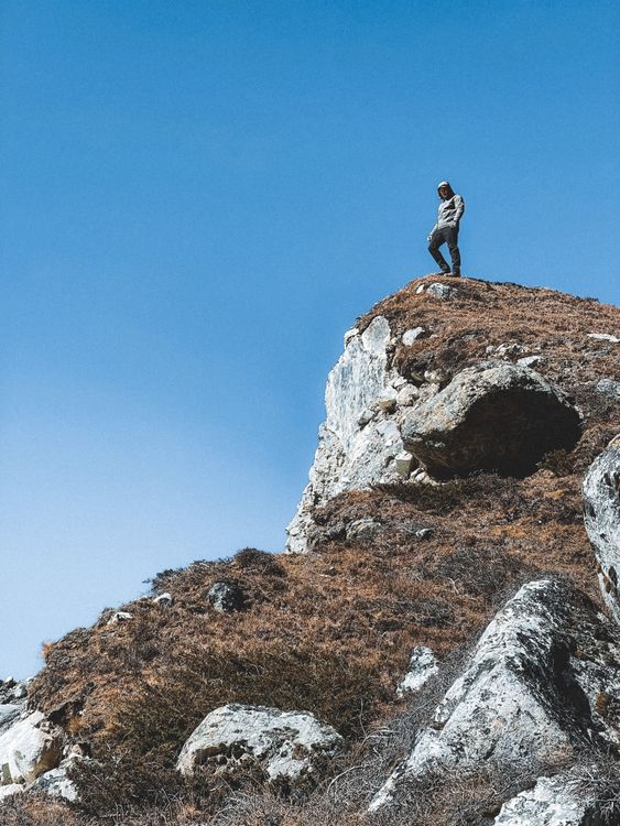 A Person Standing on the Top of the Mountain · Free Stock Photo