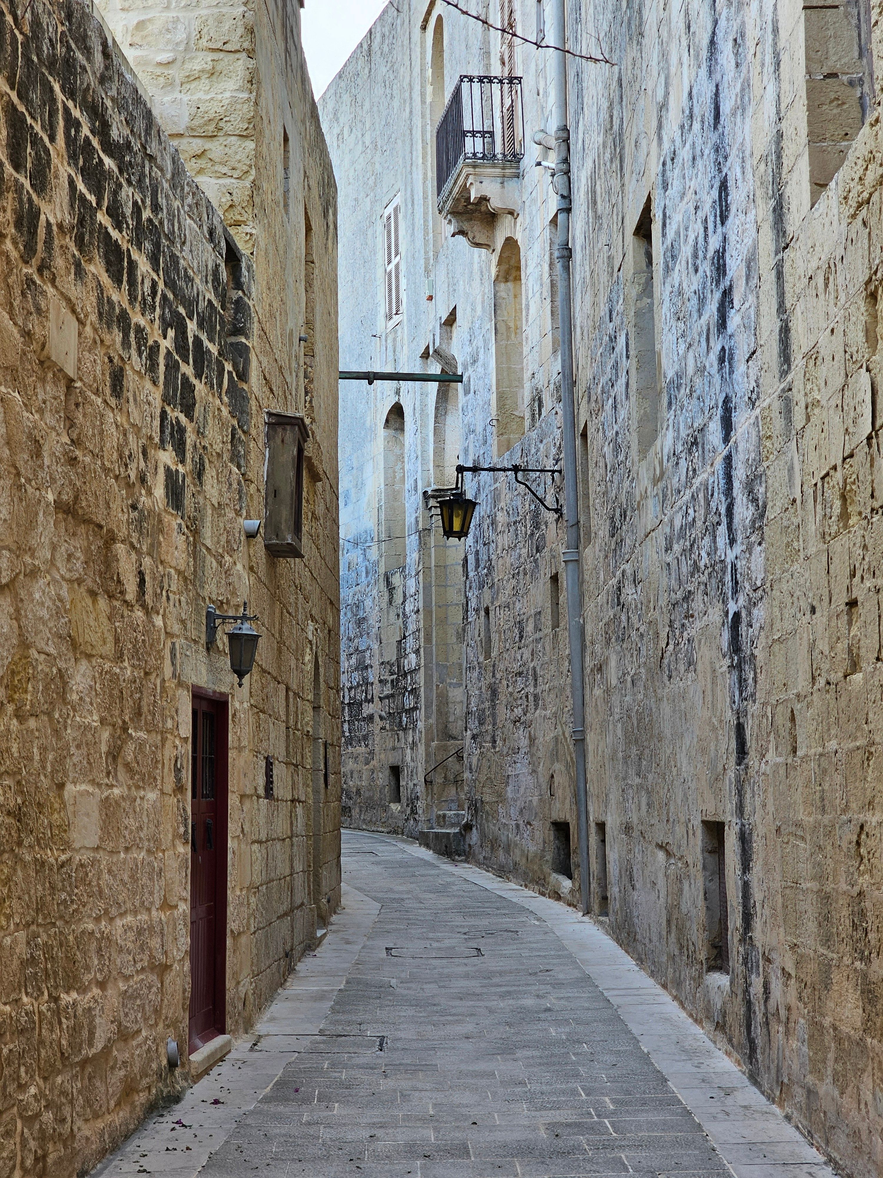 A Narrow Alley Between Stone Buildings · Free Stock Photo