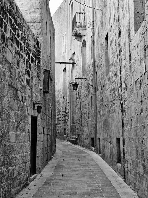 Stone Buildings Walls around Narrow Alley in Town