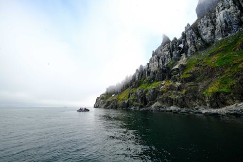 People on Pontoon on Rocky Sea Coast