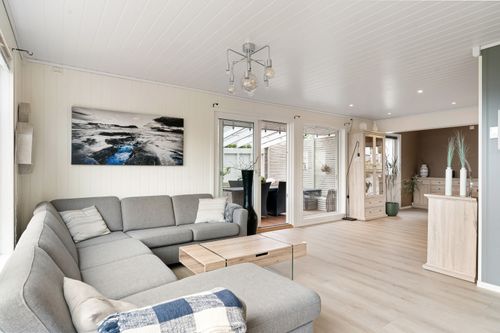 Free Bright and airy living room featuring gray sofa and minimalist decor, perfect for rentals. Stock Photo