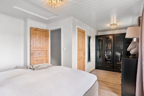 Large Bed in Bedroom with Wooden Wardrobe