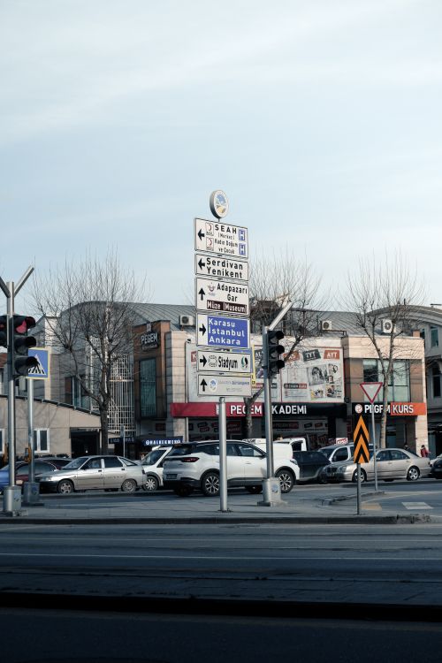 Free City intersection showing directional signs, cars, and urban landscape. Stock Photo