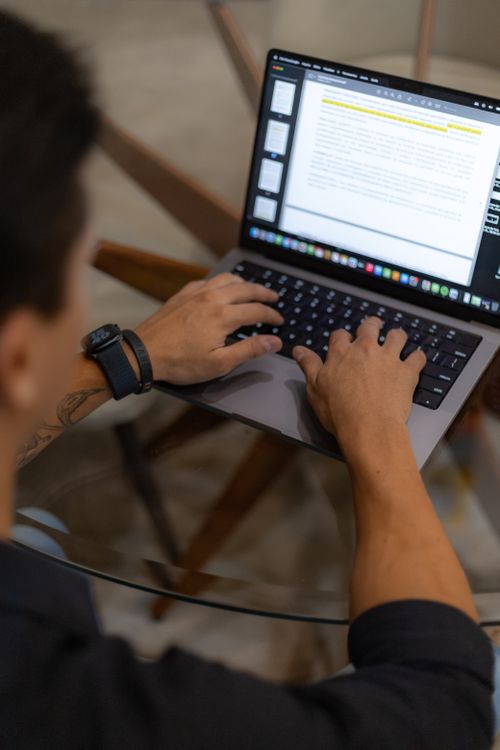 Man Writing on a Laptop · Free Stock Photo