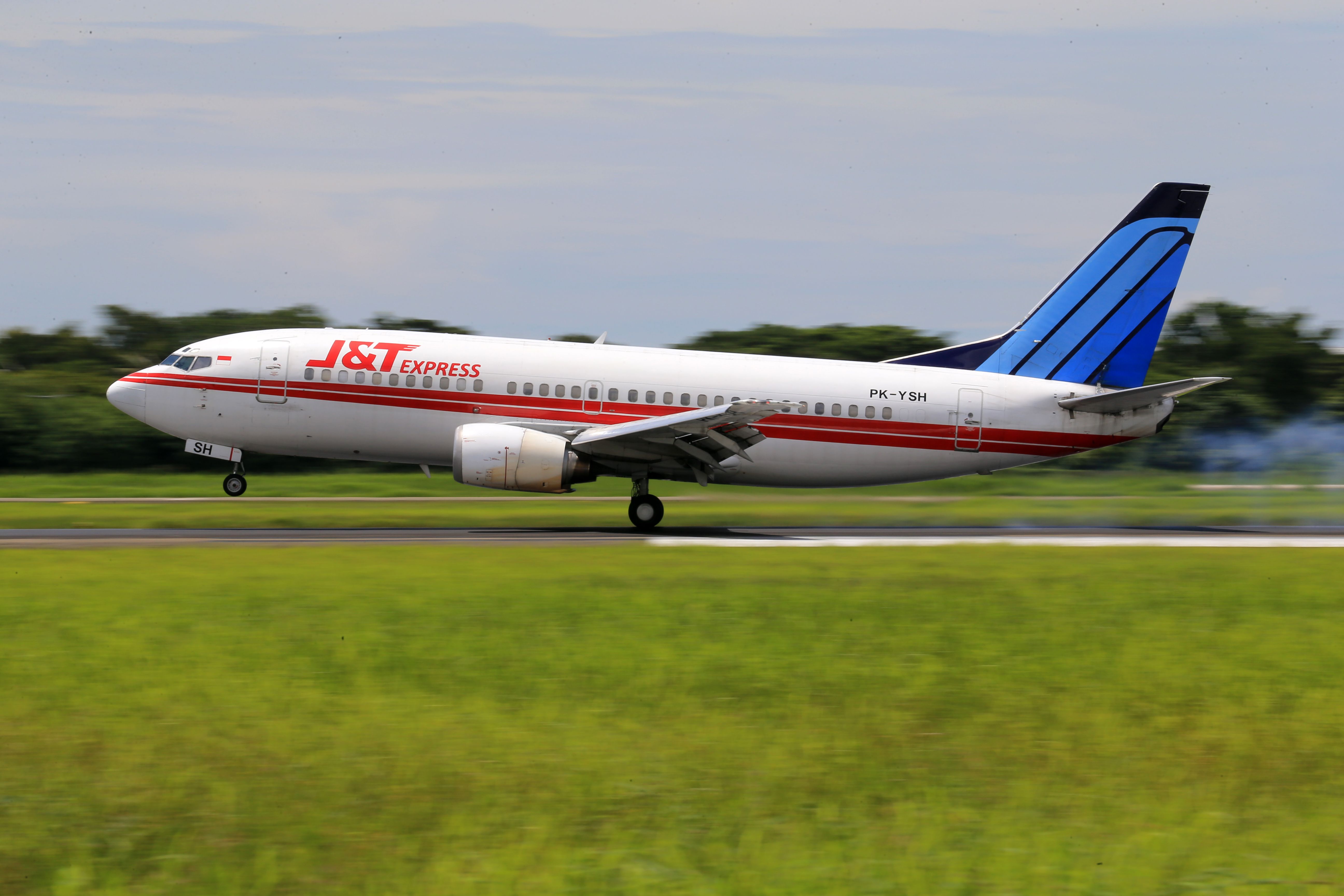 A commercial airplane taking off from an airport runway, showcasing transportation.