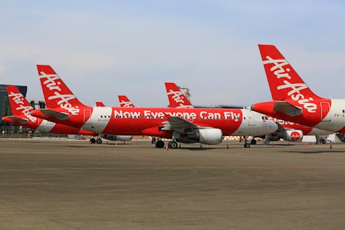 View of AirAsia Commercial Airplanes Parked at an Airport 