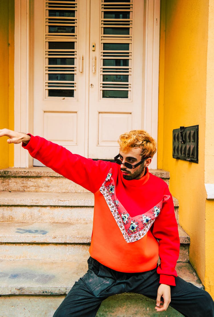 Man Wearing An Orange Sweatshirt 