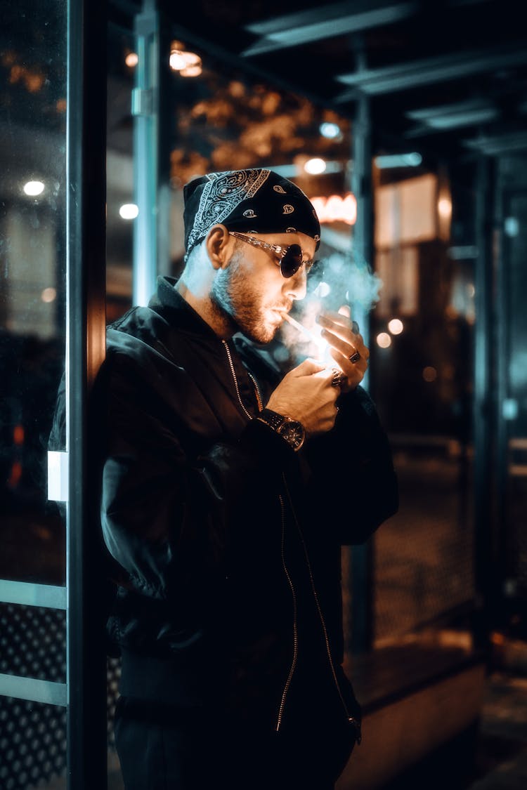 Man In Bomber Jacket Lighting Cigarette