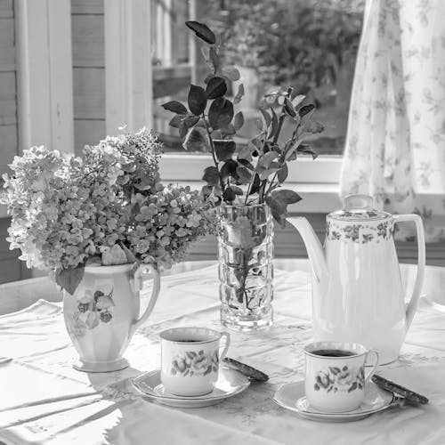 Black and White Photo of Tea Cups on a Table 