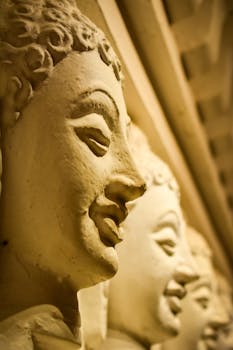 Close-up of serene Buddha statues in a temple, emphasizing spiritual and artistic beauty.
