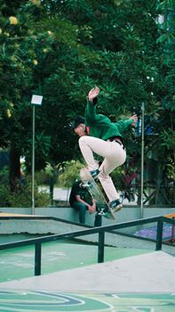 Dynamic shot of a skateboarder performing tricks at an outdoor park, showcasing skill and agility.