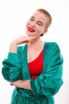 Portrait of a smiling woman in a green bathrobe and red top against a white background.