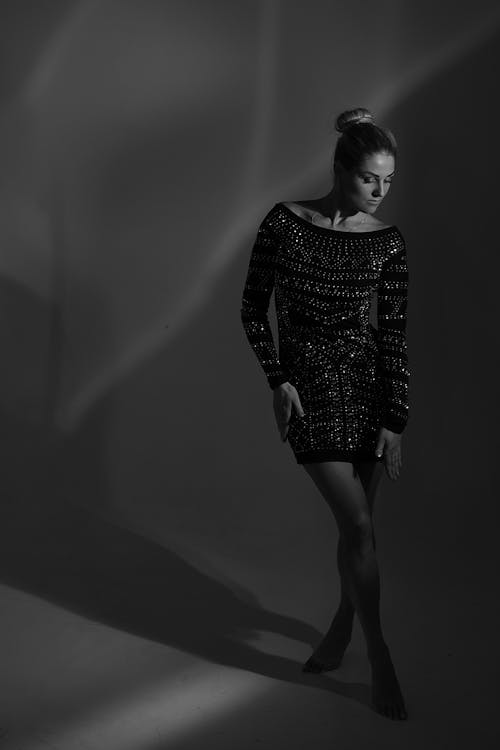 Black and White Photo of a Model Wearing a Dress 