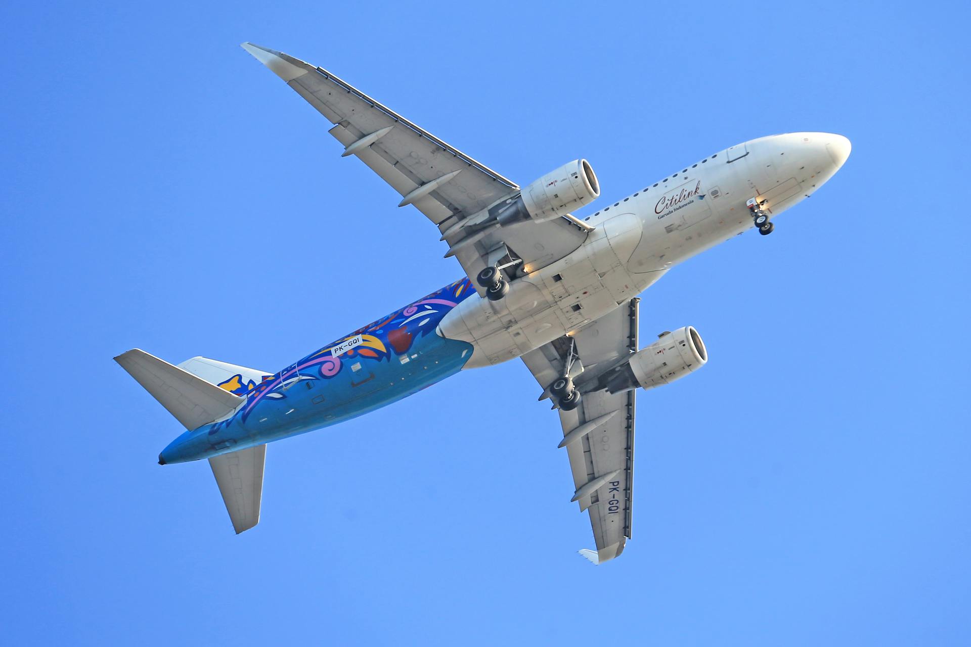 Airbus A320 Passenger Airplane of Citilink Airline Flying in Blue Sky