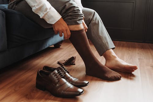 A man with socks on his feet and shoes