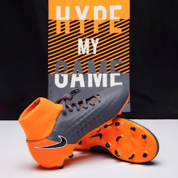 Dynamic photo of bright soccer cleats in front of 'Hype My Game' backdrop.