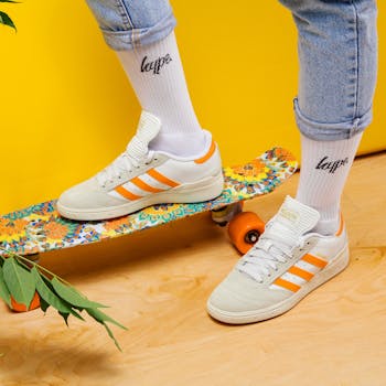 Vibrant sneakers on a floral skateboard, embodying style and youth culture.