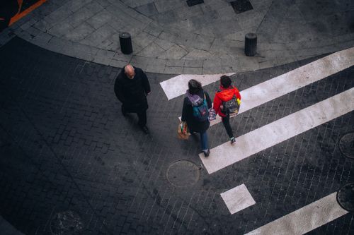 Free High-angle view of people crossing a street in Bilbao, Spain, showcasing urban life. Stock Photo