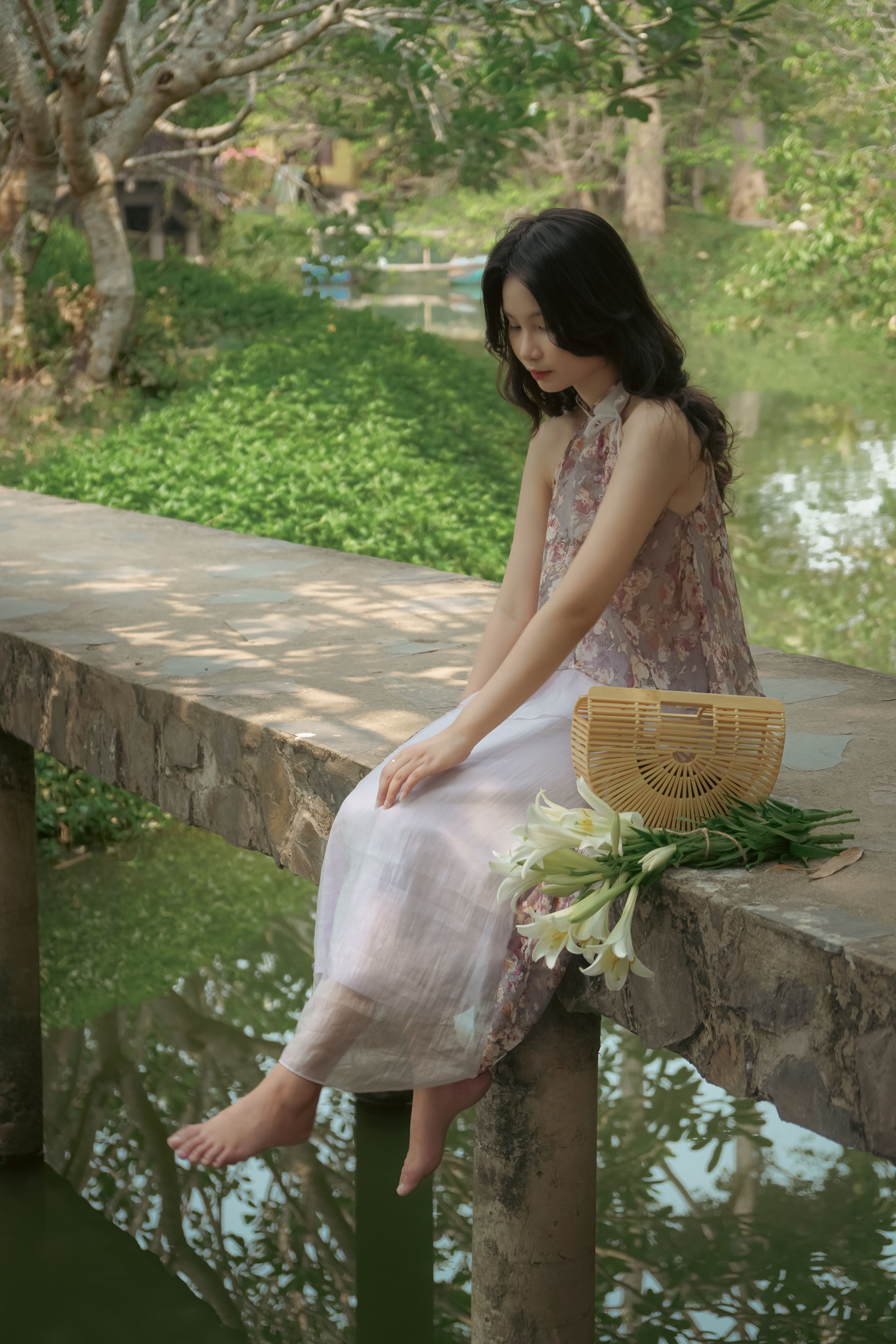 Young Woman in a Dress Sitting by the Pond in a Park · Free Stock Photo