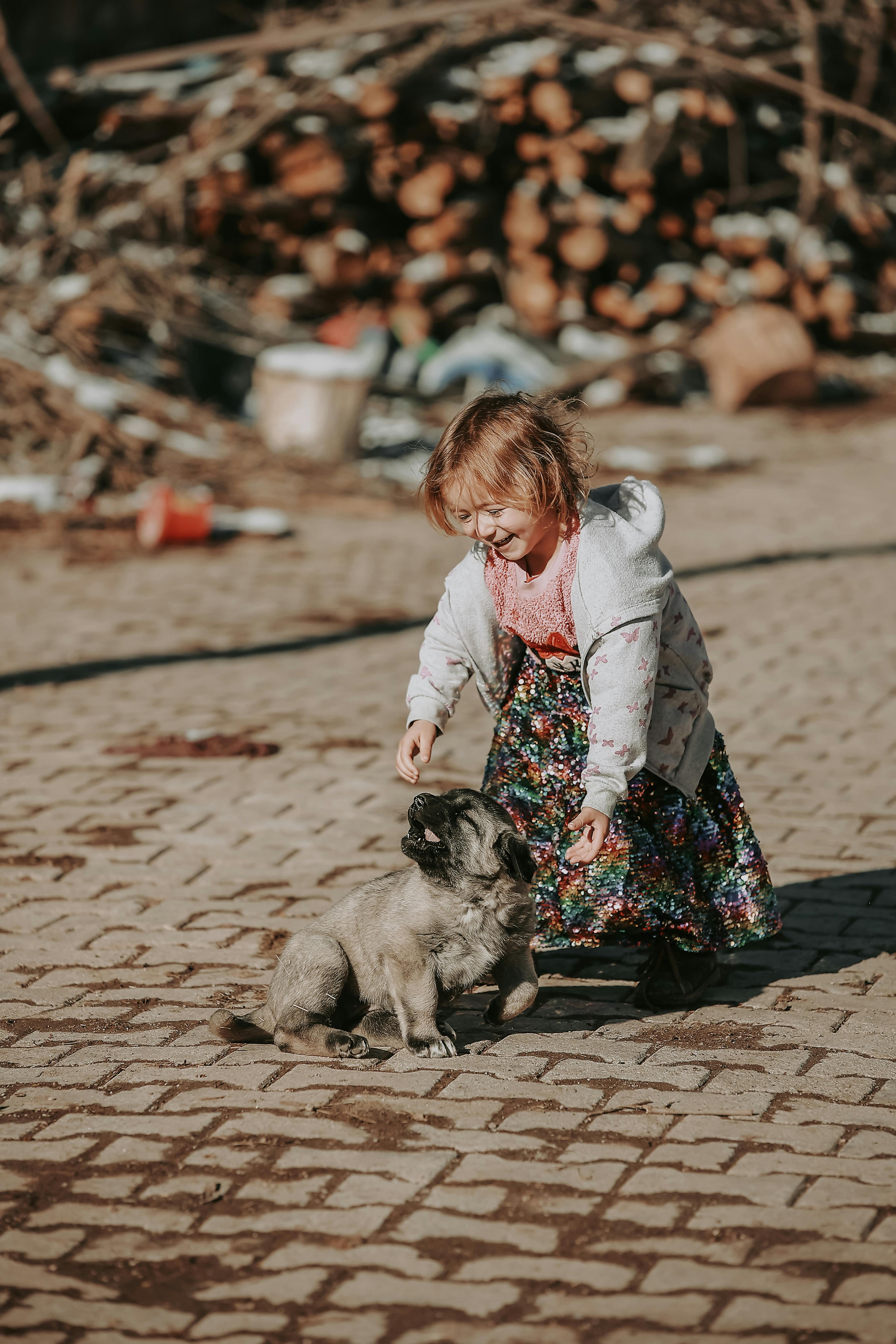 girl playing with a puppy