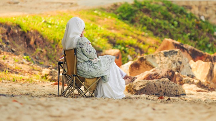 Woman In Hijab Sitting On Chair