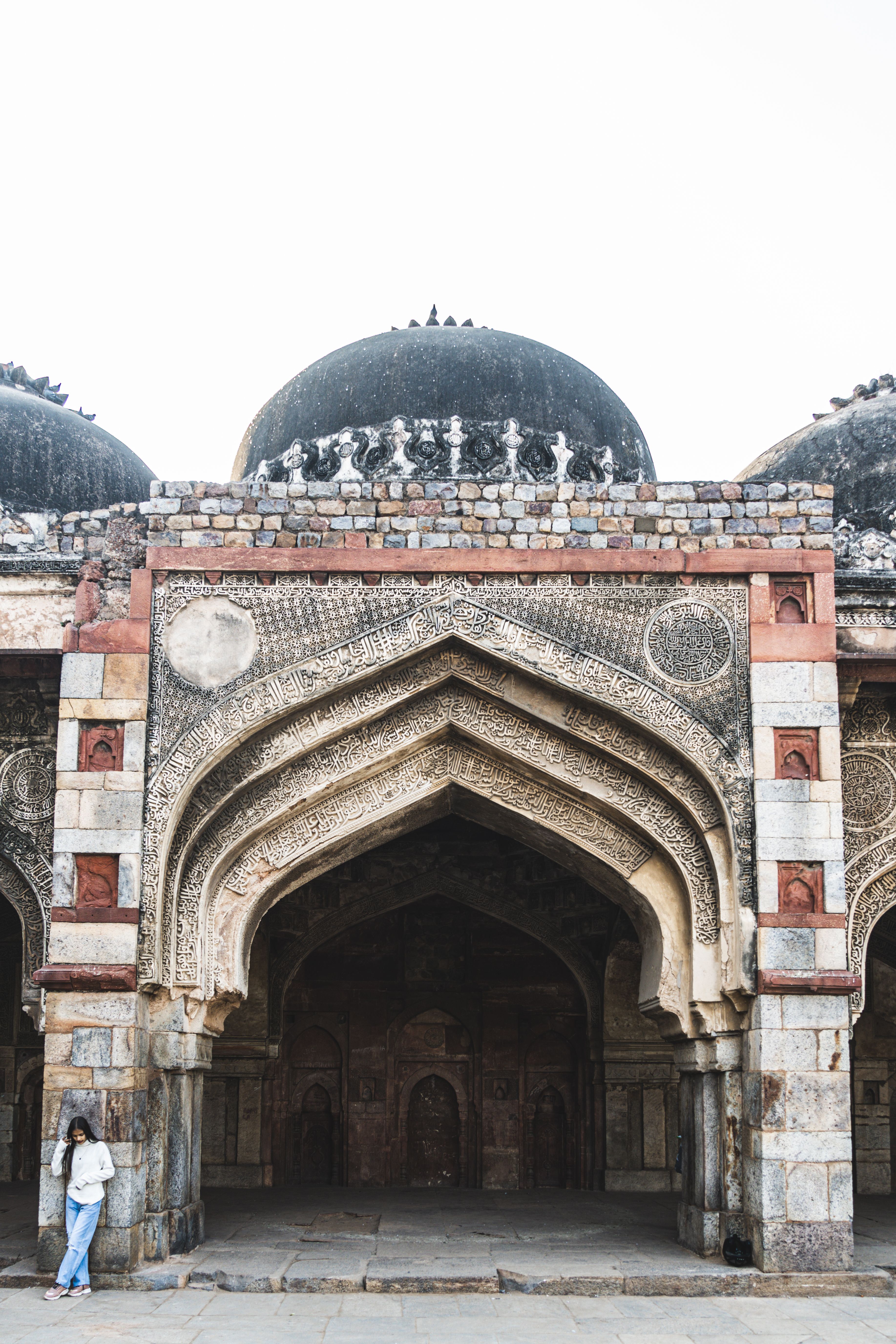 Medieval architecture of Bara Gumbad in Lodhi Gardens, New Delhi, showcasing intricate facade details.