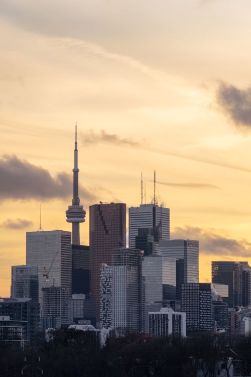 Free Stunning Toronto skyline at sunset highlighting modern skyscrapers including the iconic CN Tower. Stock Photo