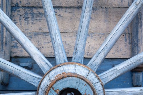 Free Detailed view of a vintage blue wooden wagon wheel with weathered texture. Stock Photo