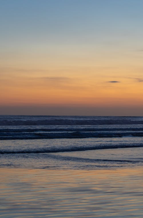 View of a Wavy Sea at Sunset