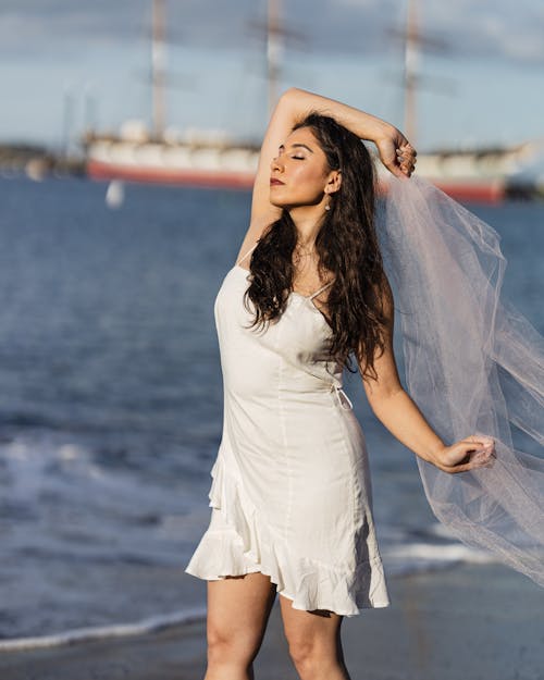 Portrait of Woman in White Dress on Sea Shore