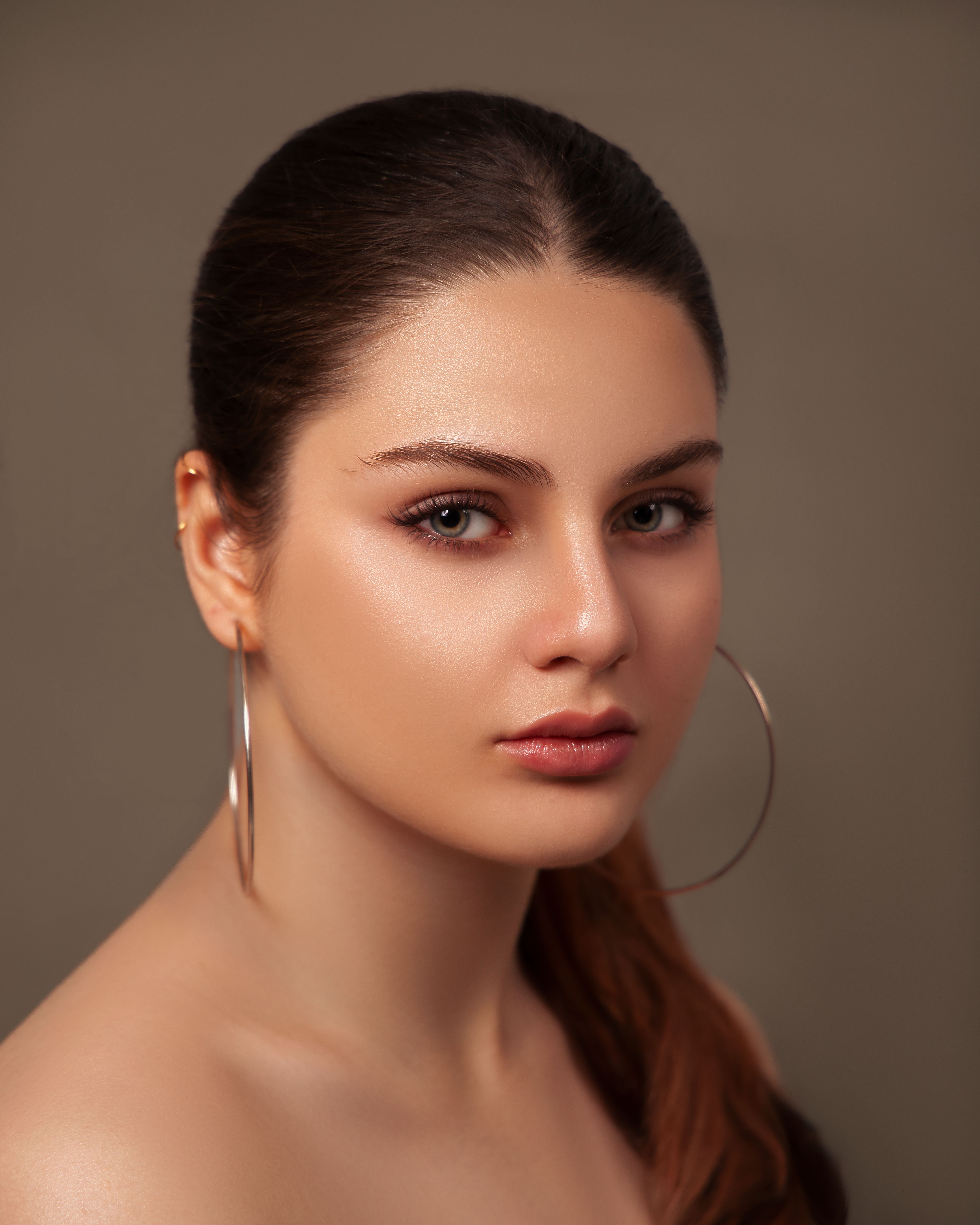 A woman with long hair and large hoop earrings · Free Stock Photo