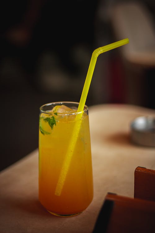 Close-up of an Orange Drink with a Straw 