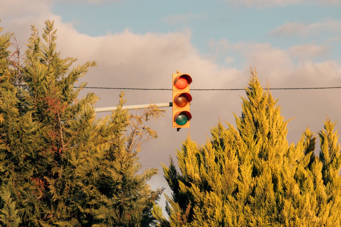 A traffic light is hanging from a wire