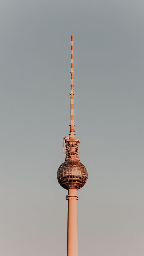 Free Striking image of Berlin's iconic TV Tower glowing warmly at sunset. Stock Photo