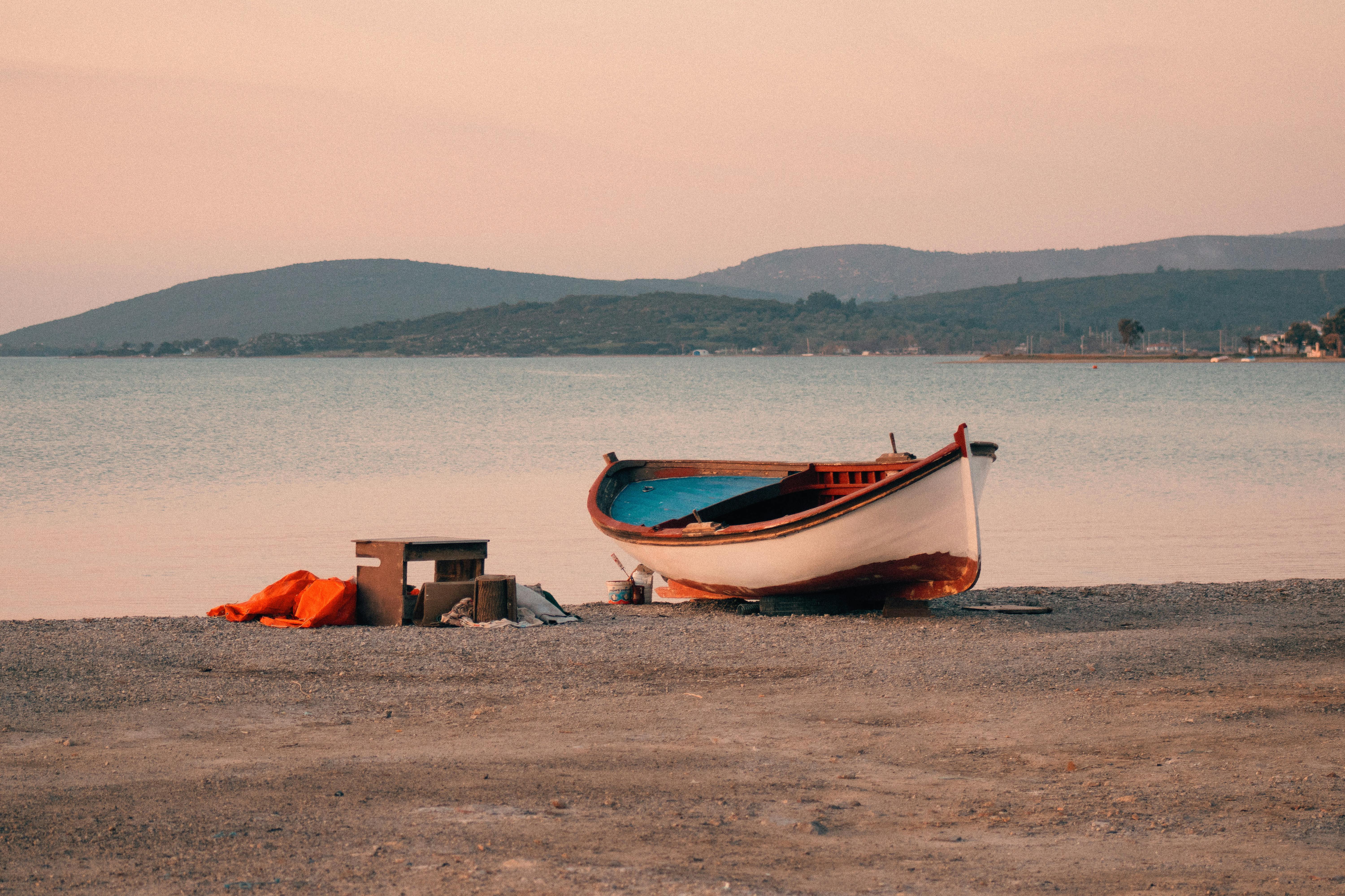 A serene boat scene on Urla’s beach in İzmir, Türkiye during a calm sunset moment