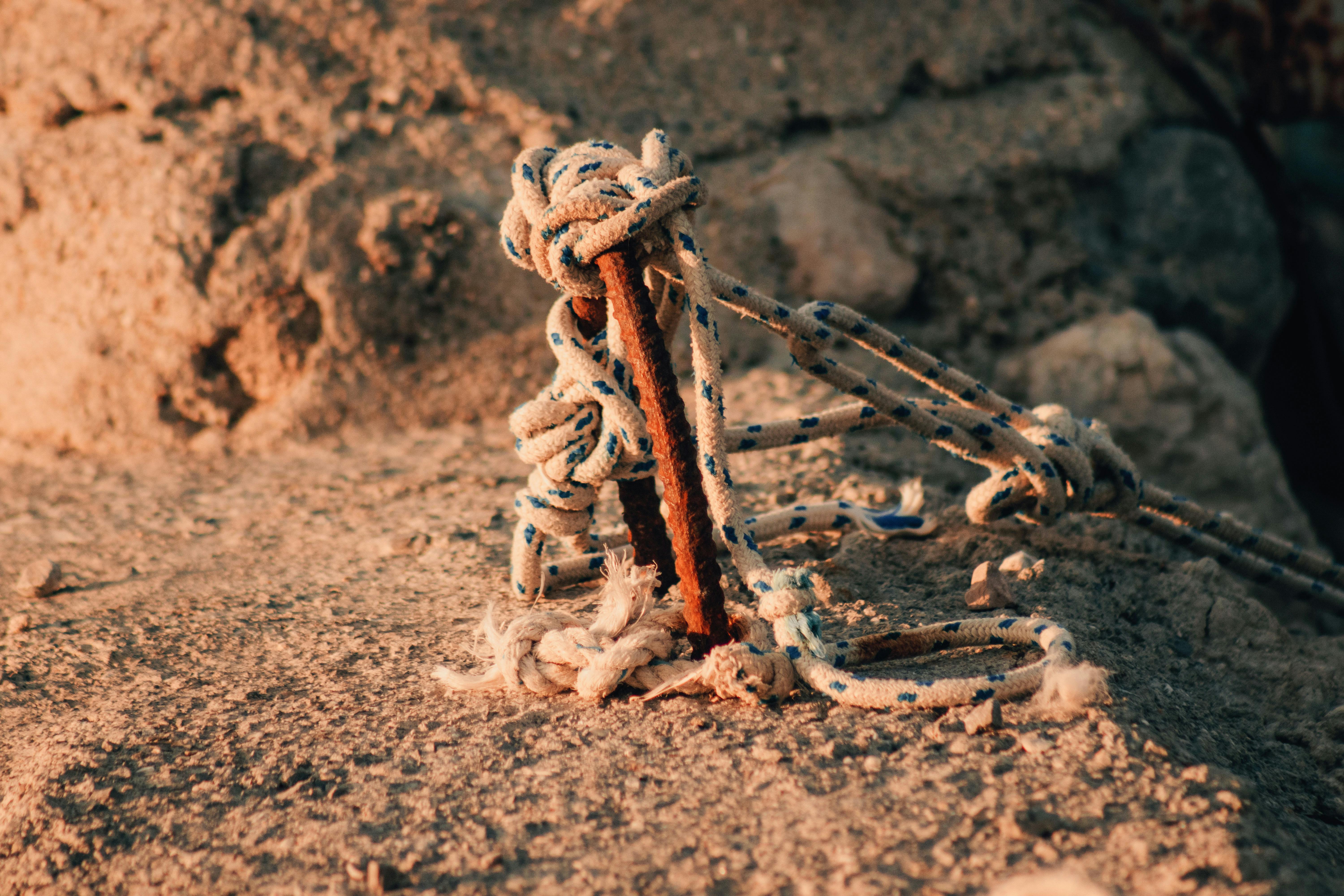 a rope and a wooden stick on the ground