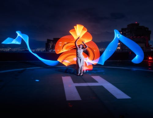 Lights behind Woman in White Dress Posing on Helipad