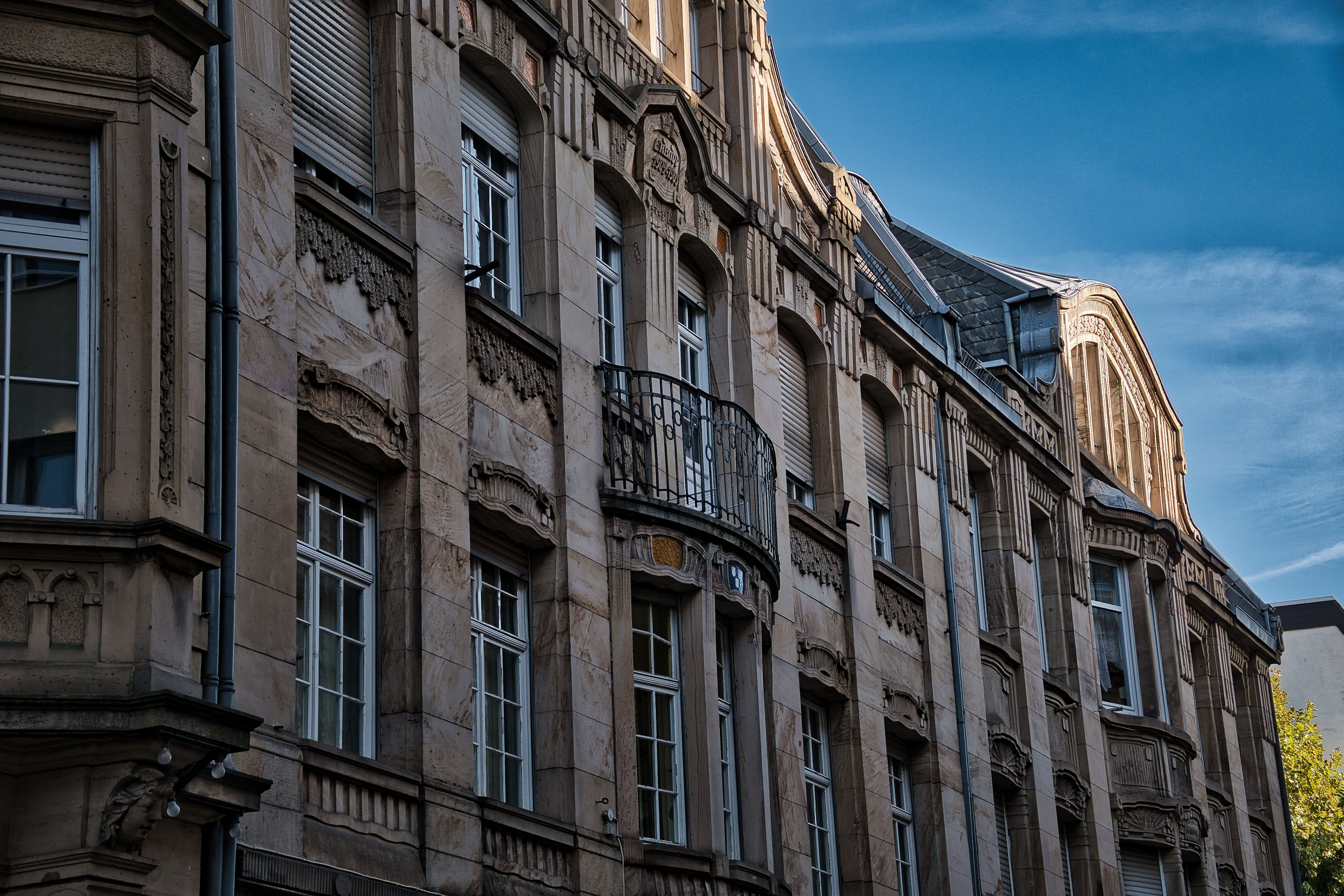 Eigenleistung bei der Sanierung: was sich lohnt – Detailed facade of a classical historic building with stone carvings and windows in Neustadt an der Weinstraße.