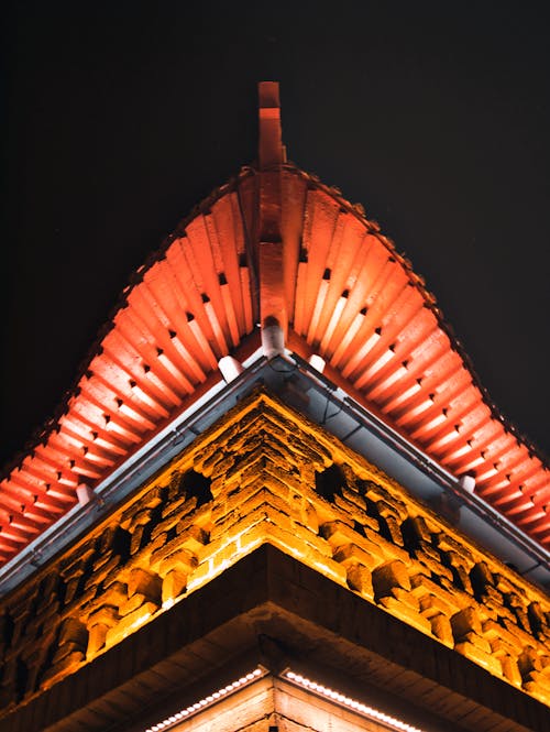 Low Angle Shot of Illuminated Exterior of a Temple 