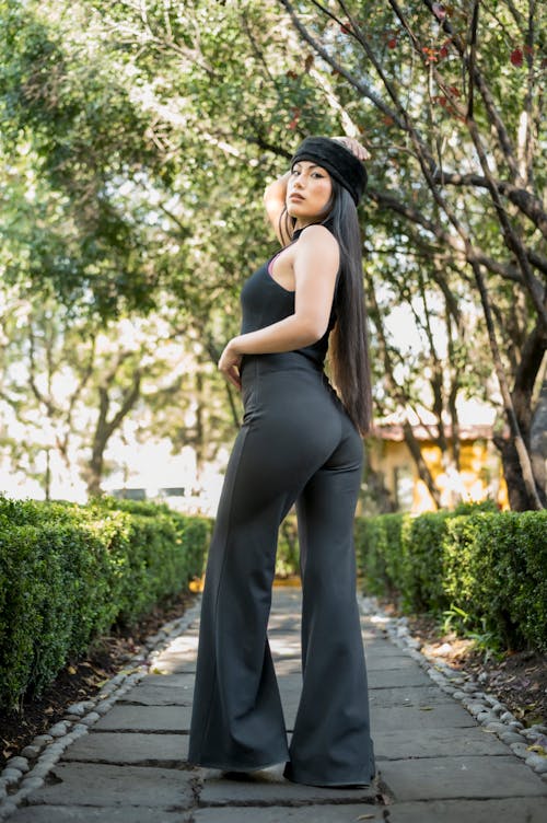 Young Woman in a Black Outfit Posing in a Park 