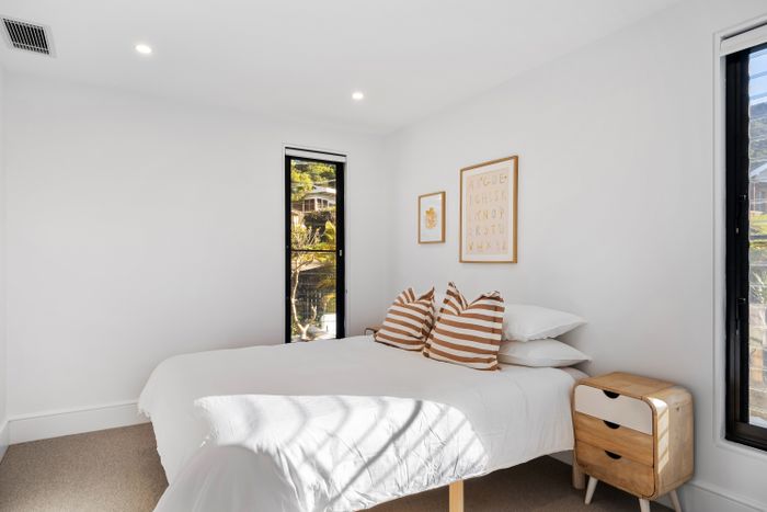 The guest bedroom, made up in white with a garden door. Photo by Lisa Anna on Pexels