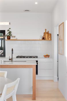 Contemporary kitchen design featuring bright white tiles and minimalist furniture.