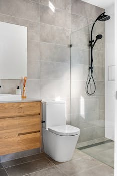 Sleek minimalist bathroom interior featuring a stylish shower and contemporary fittings.