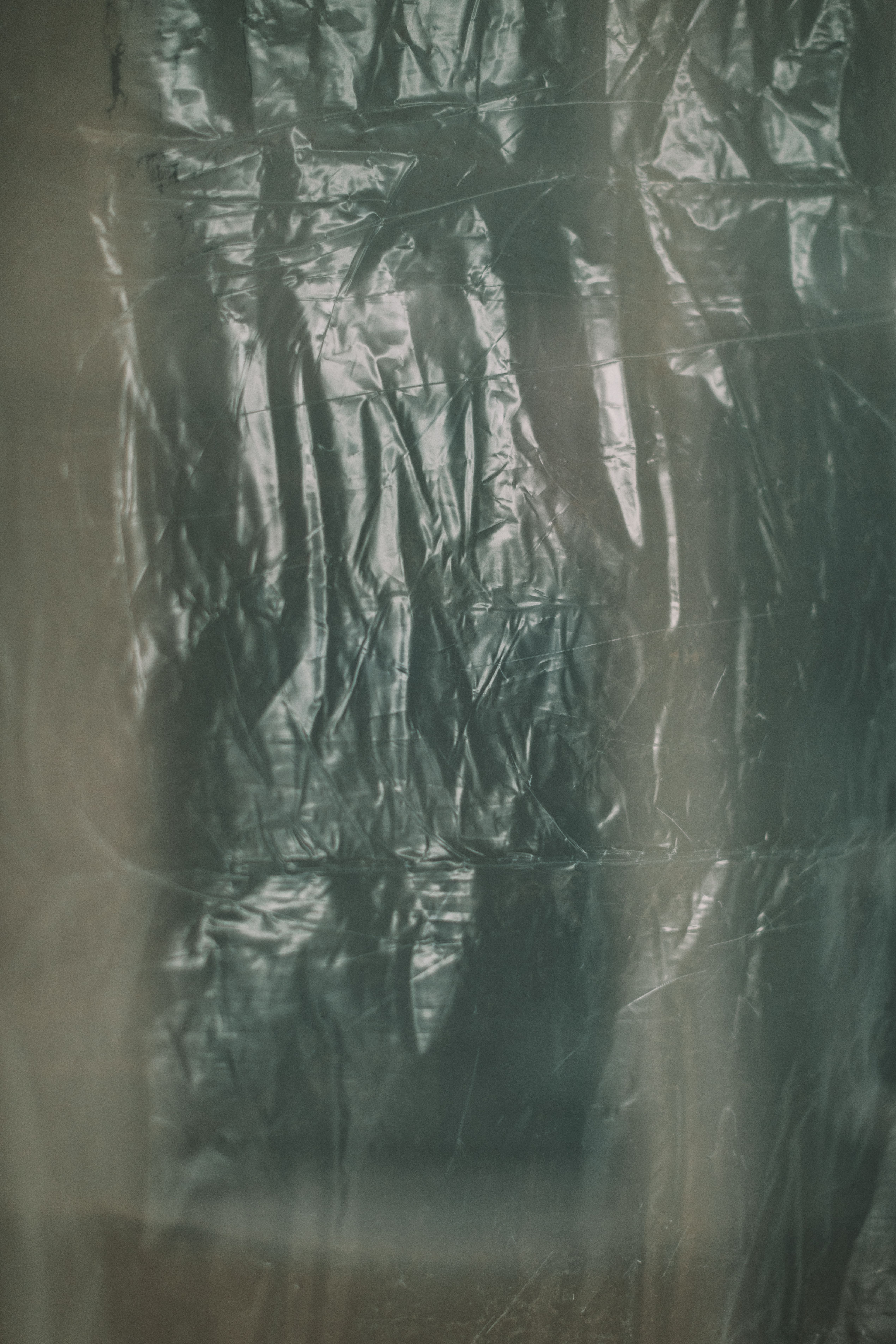Abstract close-up of crumpled plastic texture, perfect for backgrounds or design elements.