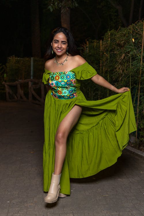 A woman in a green dress posing for the camera