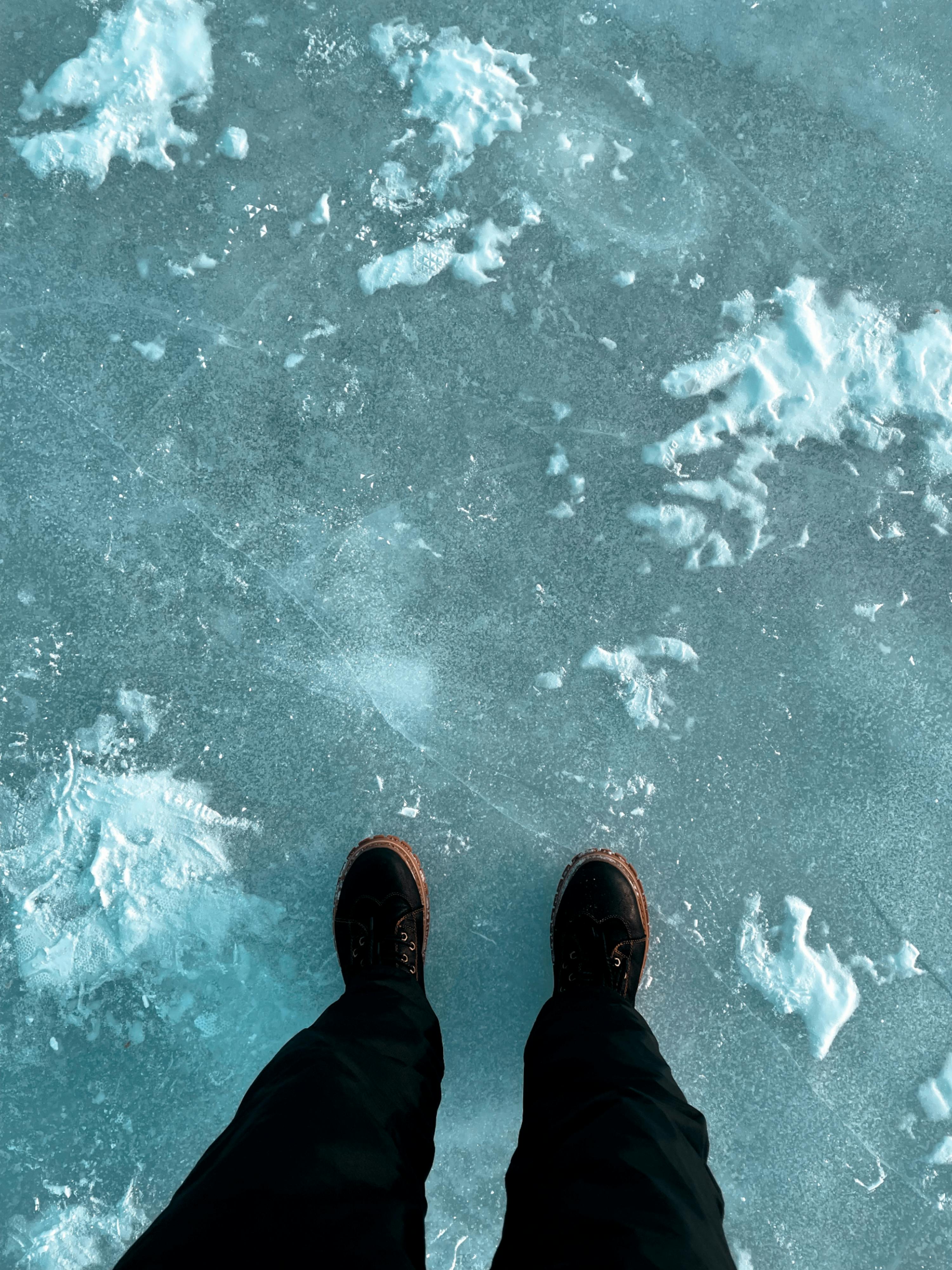 Person Standing on Frozen Water · Free Stock Photo